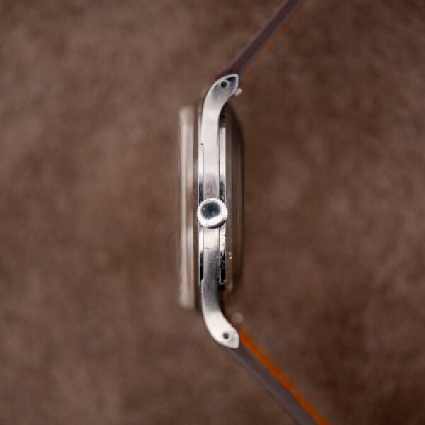 IWC automatic crown-side profile with drilled lugs and a raised curved crystal