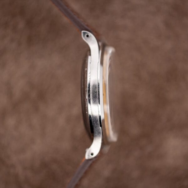 Opposite IWC case profile showing downward curved drilled lugs and solid caseback