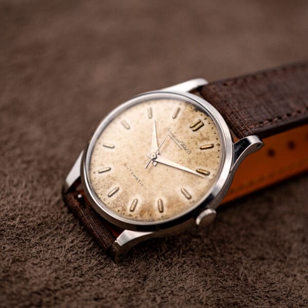 IWC automatic low frontal view with reflective dauphine hands and looped brown strap