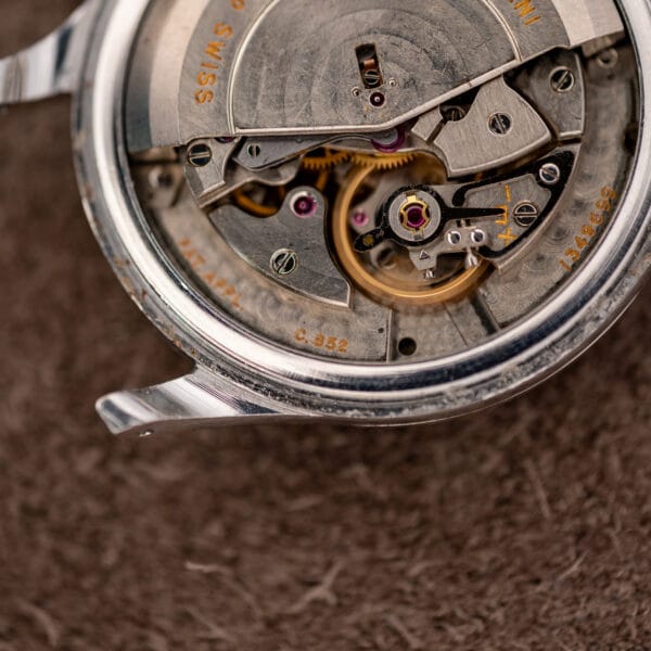 IWC automatic movement close-up showing balance assembly, engraved caliber marking and serial number