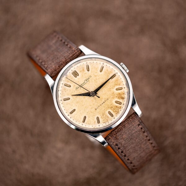 Alternate IWC stand view with central seconds hand and stainless steel bezel