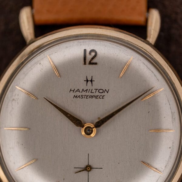 Hamilton Masterpiece dial close-up showing the applied twelve, pointed hands and printed Hamilton signature