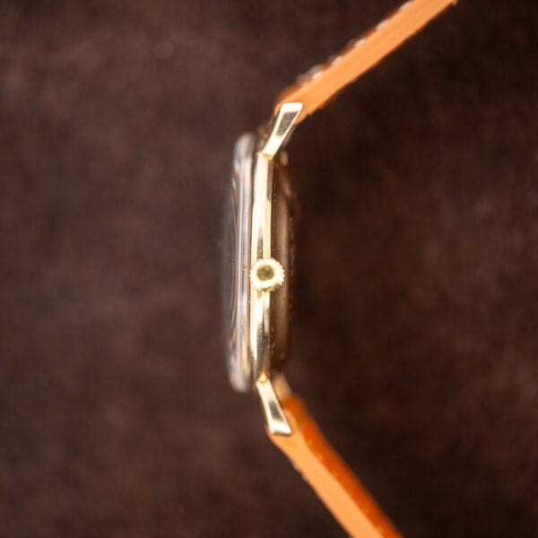 Crown-side profile of Hamilton Masterpiece showing the ridged winding crown, raised crystal and curved lugs