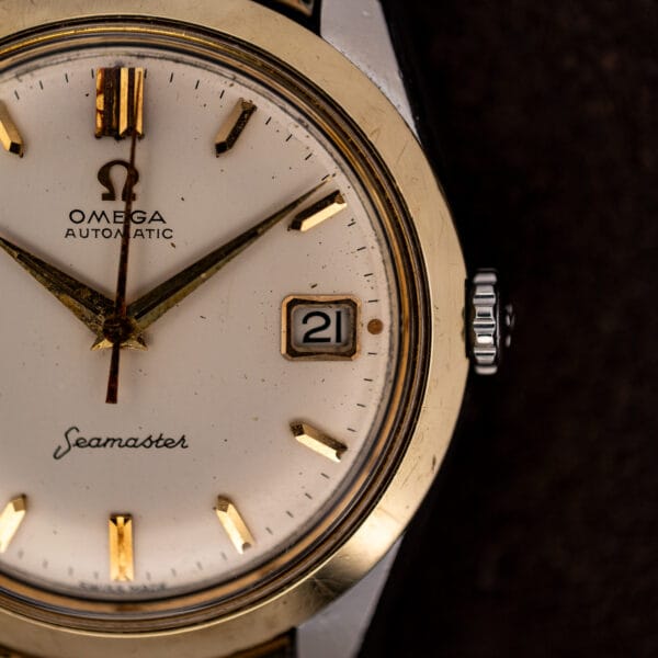 Omega Seamaster 14744-1 dial detail showing the framed date window, gold-tone markers and winding crown