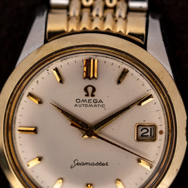 Upper dial of Omega Seamaster 14744-1 showing the applied Omega emblem and faceted twelve o'clock marker