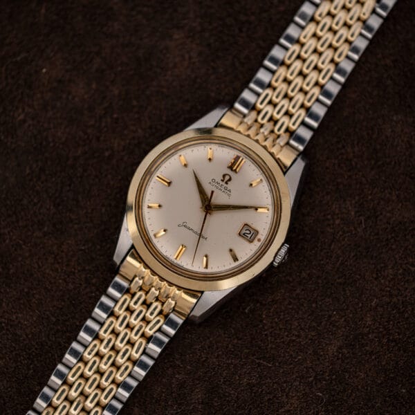 Omega Seamaster 14744-1 displayed face-up with its two-tone bracelet extended from lower left to upper right