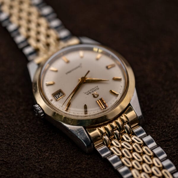 Omega Seamaster 14744-1 viewed from twelve o'clock, with the crown and upper bracelet attachment in view