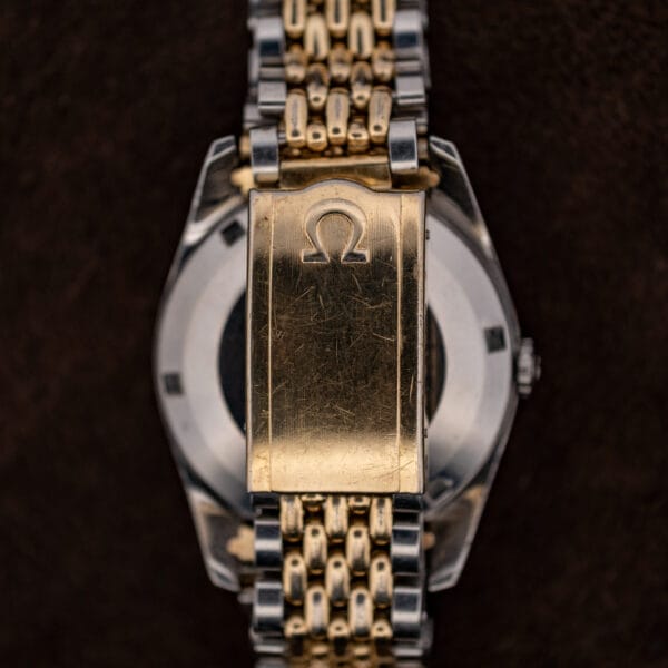 Omega Seamaster 14744-1 bracelet clasp with raised Omega emblem, shown closed across the caseback