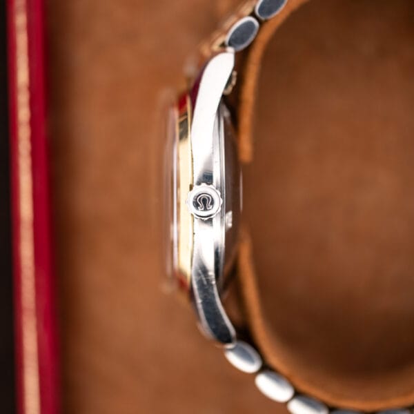 Crown-side profile of Omega Seamaster 14744-1 showing the Omega-signed crown, domed crystal and two-tone case