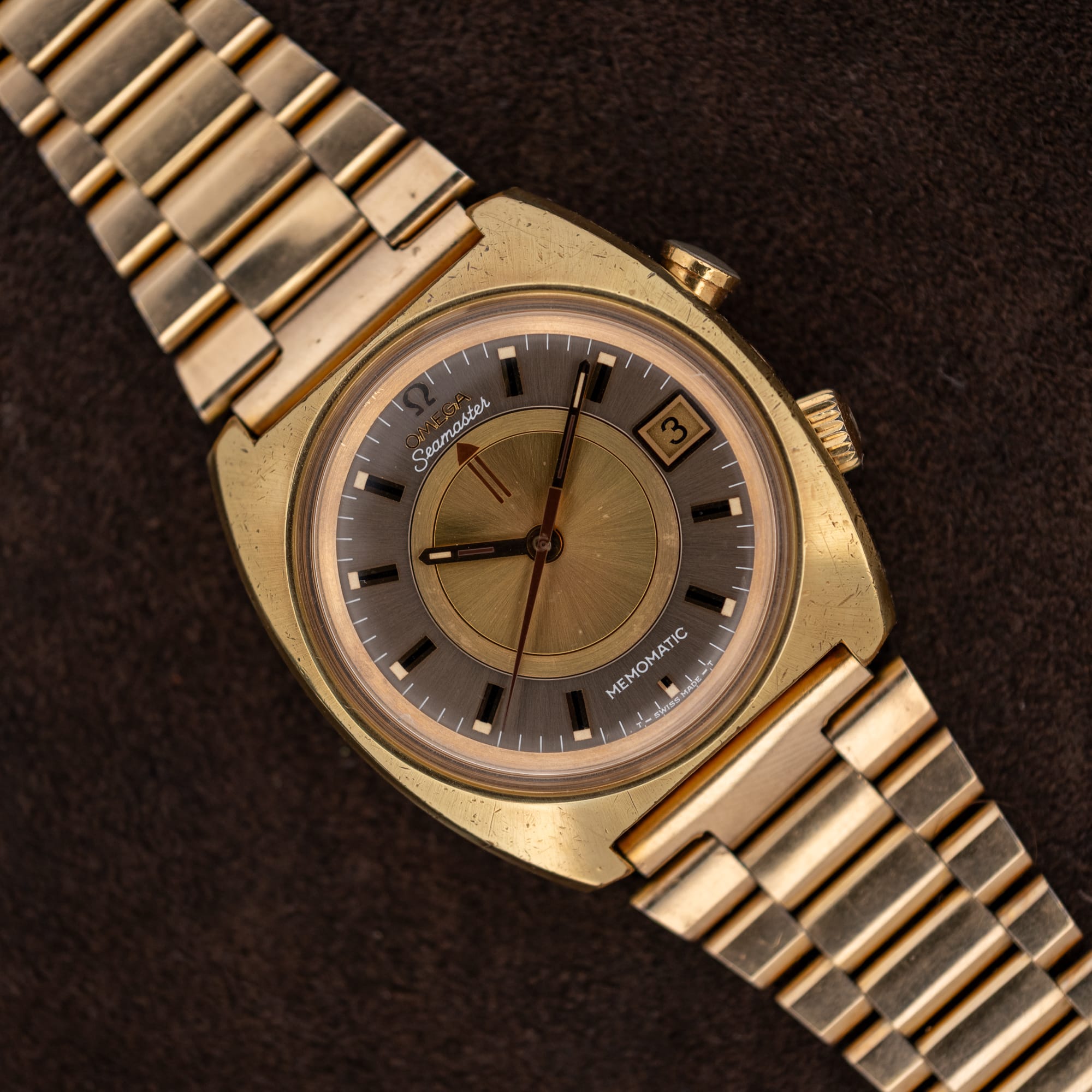 DSCF7308 Omega Seamaster Memomatic 166.072 with gold and anthracite dial and linked bracelet resting diagonally on brown fabric