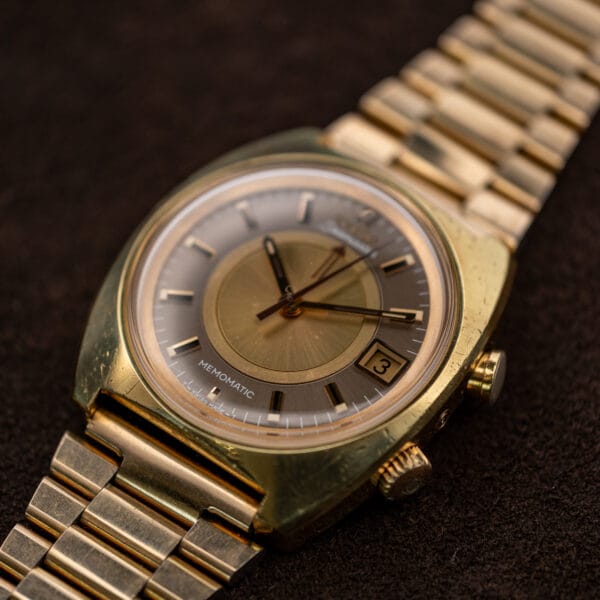 Angled Omega Memomatic 166.072 dial view with raised crystal and both right-side controls visible