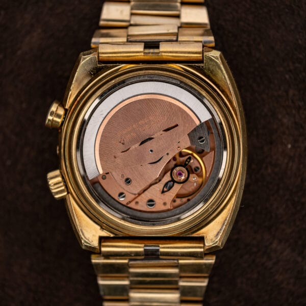 Opened Omega Memomatic 166.072 showing its automatic movement, copper-toned rotor and balance assembly