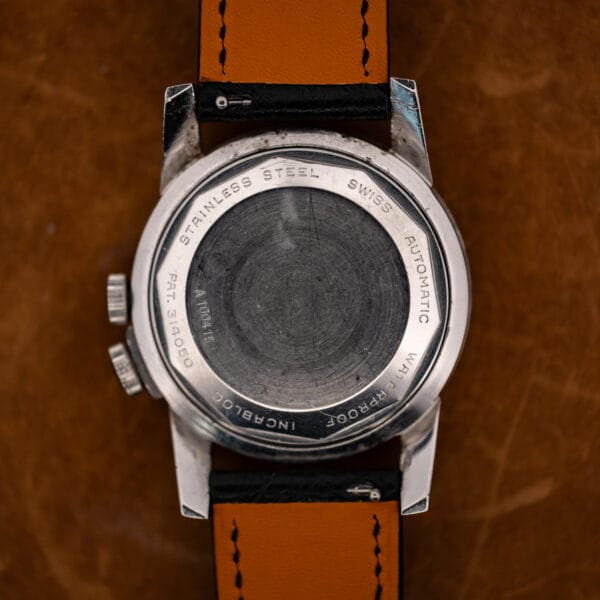 Rear view of the Glycine Airman showing its engraved steel caseback and stitched undersides of the strap