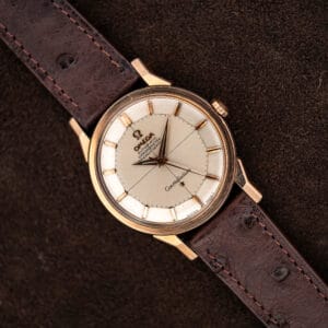 Omega Constellation 167.005 with silver crosshair pie pan dial, rose gold capped case, and brown ostrich strap