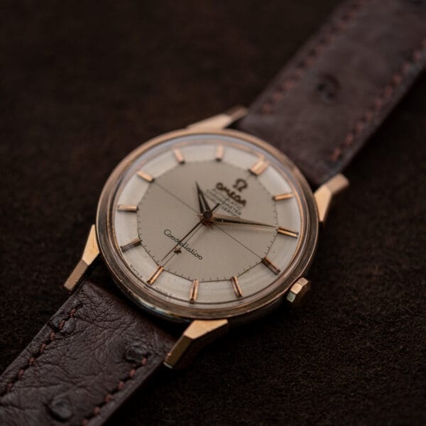 Angled crown side view of Omega 167.005 with dogleg lugs and a silver crosshair dial