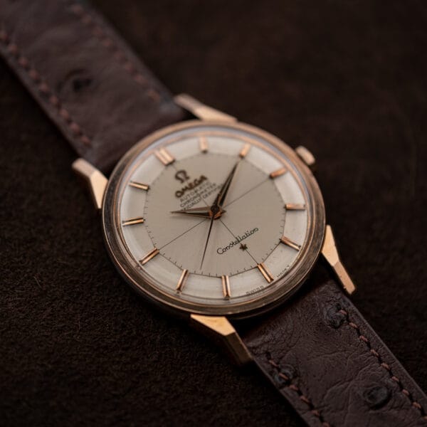 Oblique Omega Constellation 167.005 face with raised crystal, applied hour markers, and dauphine hands