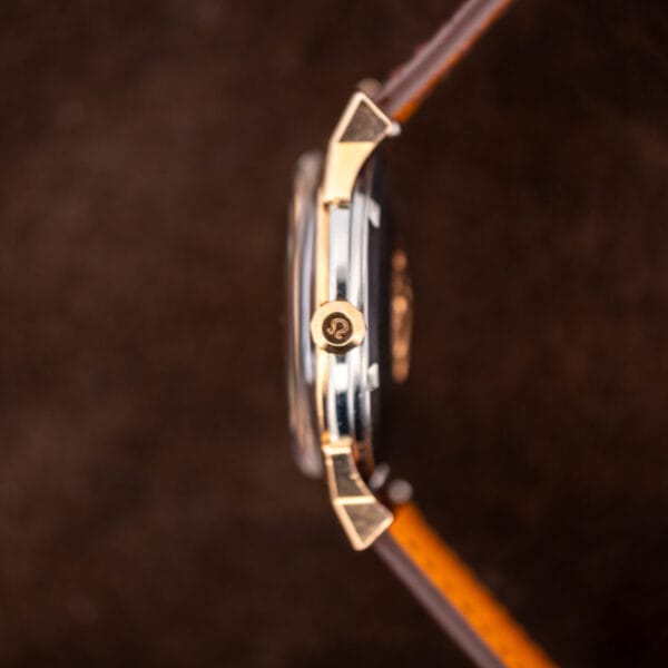 Faceted Omega signed crown and contrasting case metals on the side of Constellation reference 167.005