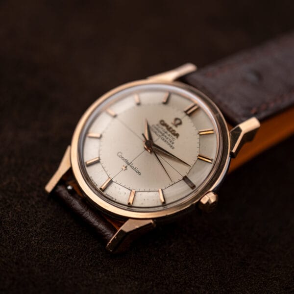 Close angled Omega Constellation 167.005 view emphasizing the pie pan dial facets and rose toned bezel