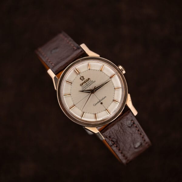 Omega Constellation 167.005 facing left diagonally, with silver crosshair dial and chocolate brown ostrich strap