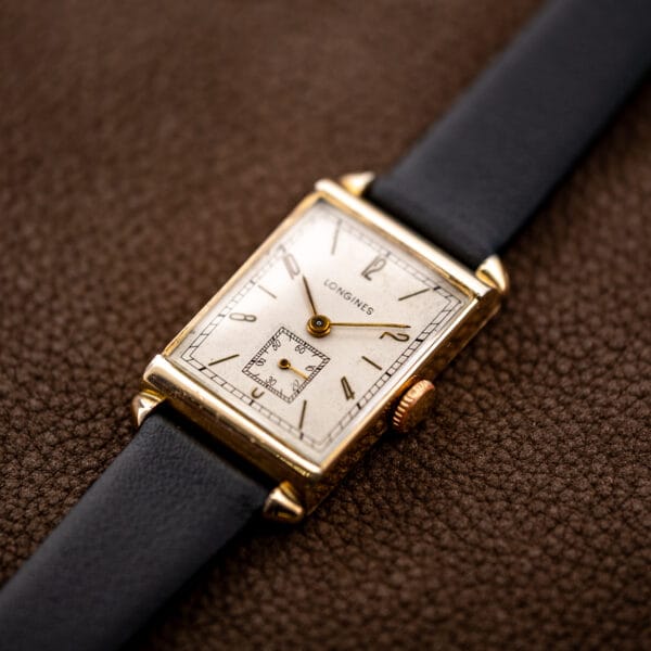 Crown-side view of the Longines Art Deco tank, showing its rectangular case and black leather strap