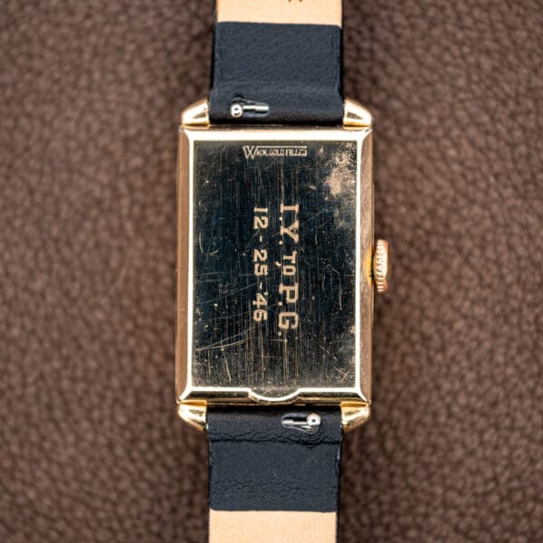 Longines caseback engraved I.Y. TO P.G. and dated December 25, 1946, between the leather strap ends