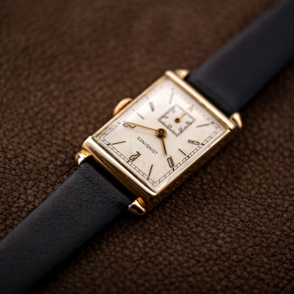 Longines Art Deco tank viewed from the upper lugs, with the dial and black strap angled away