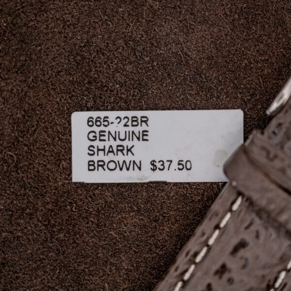 Brown shark skin strap label beside the stitched strap fitted to Omega Seamaster reference 176.007