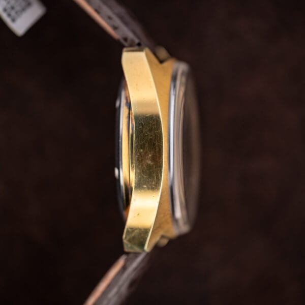 Left case profile of Omega Seamaster 176.007 showing cushion contours and raised crystal above the bezel