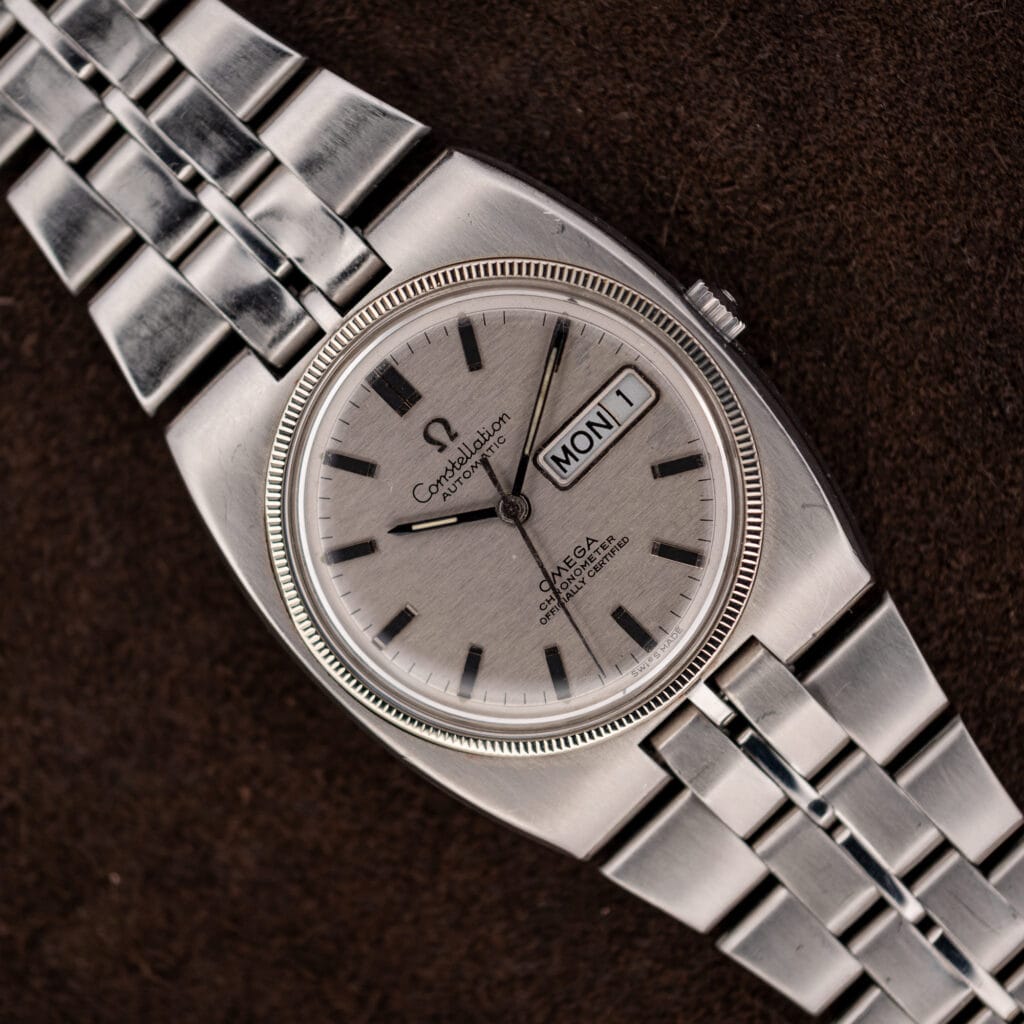 Omega Constellation 168.045 silver day-date dial and integrated steel bracelet in a diagonal close view