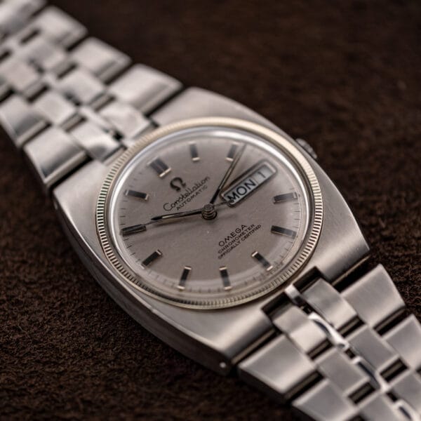 Low oblique Omega Constellation view with silver dial, baton markers and integrated bracelet connection