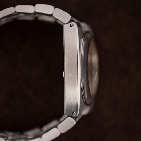 Opposite Constellation 168.045 case profile with visible bracelet attachment screws and raised crystal edge
