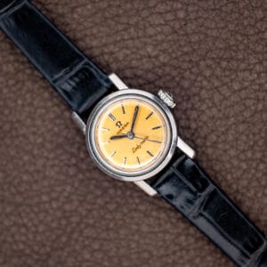 Omega Ladymatic 11000 SC with lemon dial, slim baton markers and black leather strap