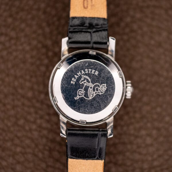 Ladymatic 11000 SC caseback bearing Seamaster lettering and hippocampus emblem inside a notched perimeter