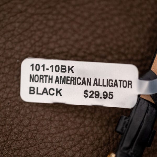 Strap tag photographed with Omega Ladymatic, marked North American Alligator, Black and model 101-10BK