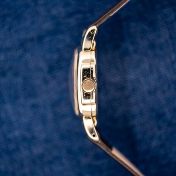 Hamilton Roland crown-side profile showing plain winding crown, curved crystal and drilled fixed lugs