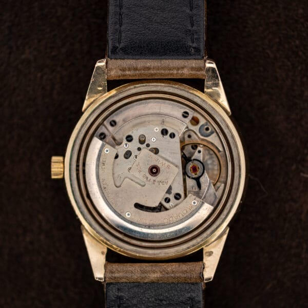 Open Movado Automatic case displaying signed rotor and seventeen jewel movement inscription