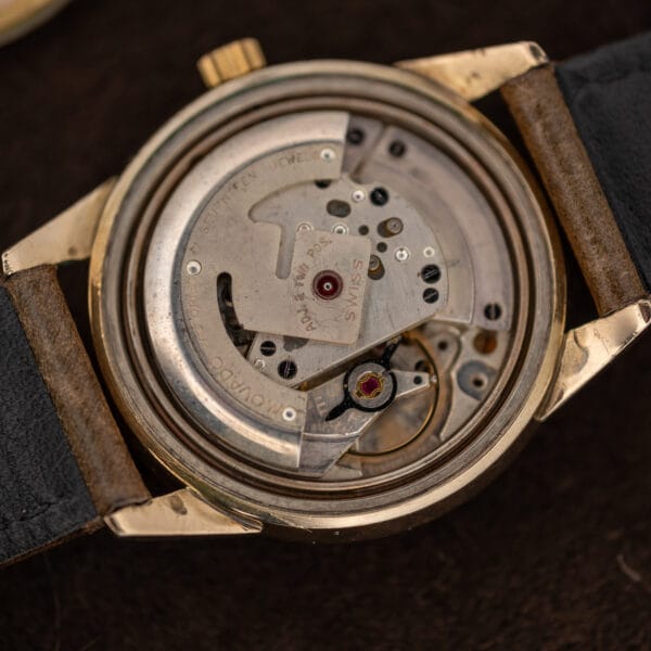 Movado movement close-up with Swiss signature and two-position adjustment marking on rotor