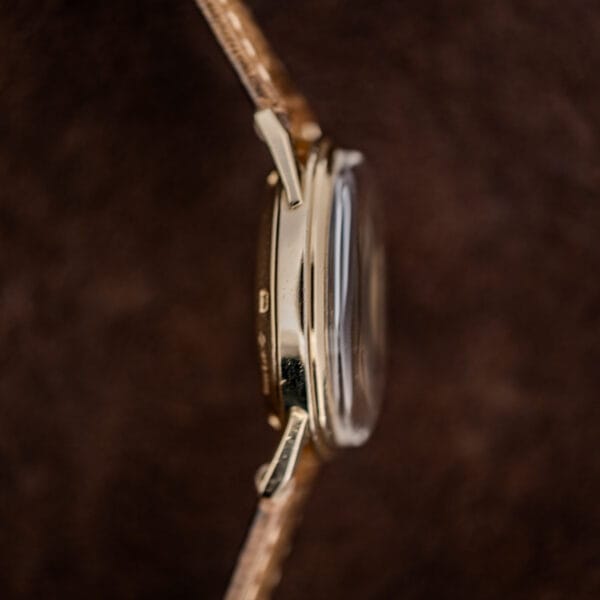 Movado Automatic opposite case profile with raised crystal and downward curved lugs