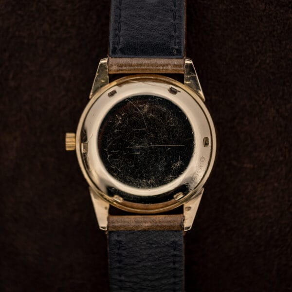 Movado 64389 exterior caseback with six tool recesses and leather strap undersides