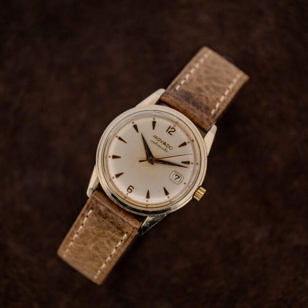 Front angled Movado 64389 stand view showing applied numerals and gold-tone markers