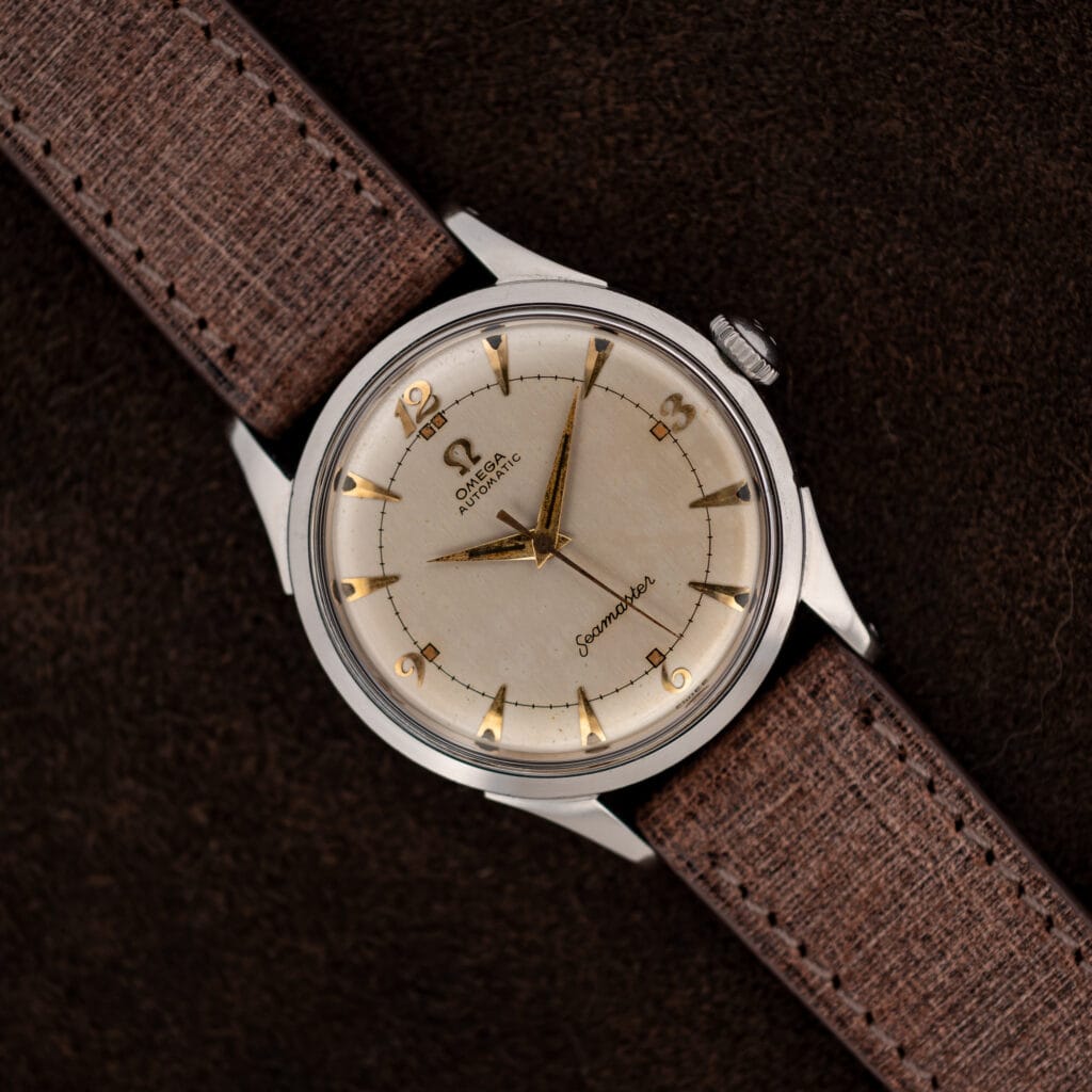 Omega Seamaster 2635-9 SC with eggshell dial, applied Arabic numerals, dauphine hands, and brown textured strap