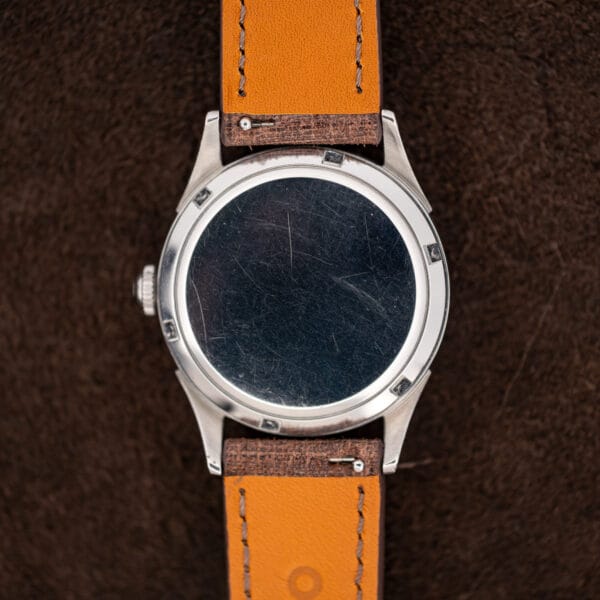 Plain stainless steel caseback of Omega Seamaster 2635-9 SC showing six opening notches and strap undersides