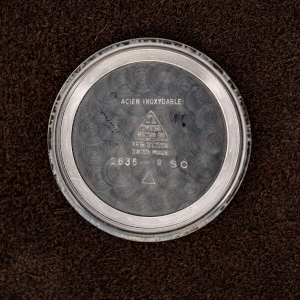 Omega inner caseback stamped 2635-9 SC, ACIER INOXYDABLE, and Swiss manufacture markings beneath the triangular logo