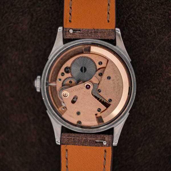 Open Omega Seamaster 2635-9 SC revealing its copper toned bumper automatic movement and signed winding weight