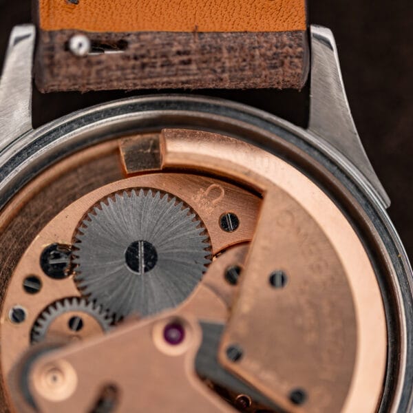 Closeup of the Omega caliber 354 stamp beside a toothed wheel in Seamaster reference 2635-9 SC