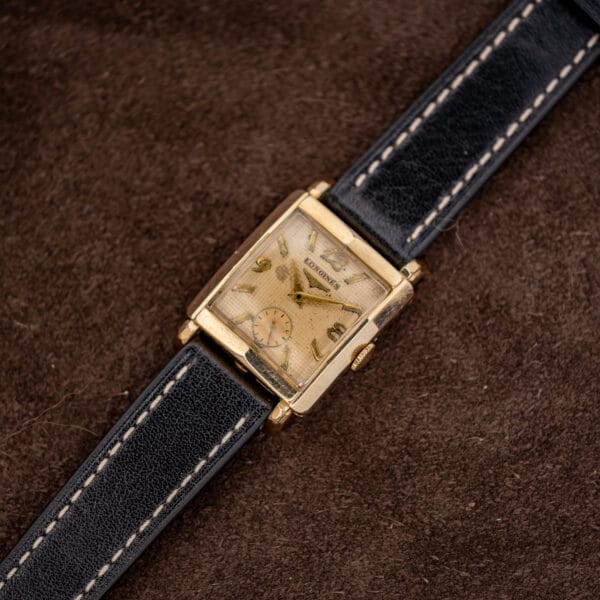Diagonal Longines square case portrait with textured dial and full stitched black leather strap
