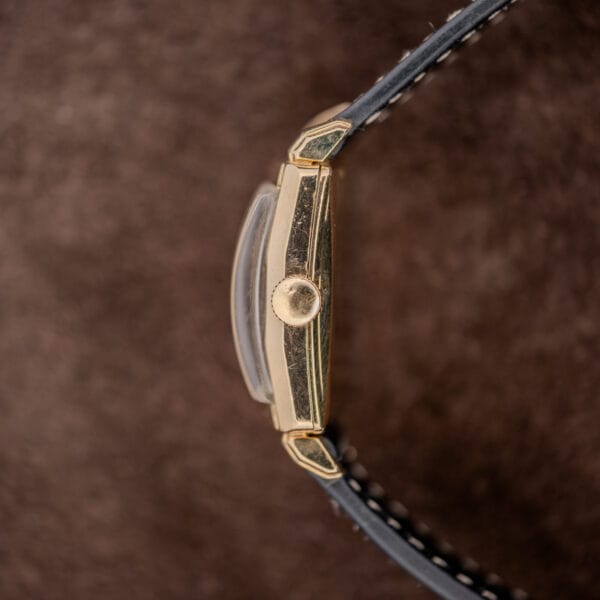 Longines winding-crown profile with raised curved crystal, straight case flank and short shaped lugs