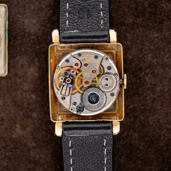 Longines manual winding movement with seventeen jewel inscription exposed inside its square gold filled case