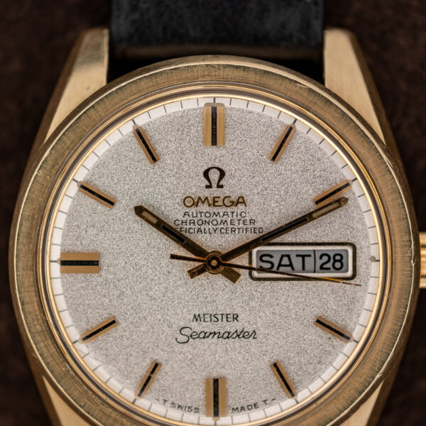 Omega Seamaster chronometer dial close-up with Meister signature, day-date display and applied baton hour markers