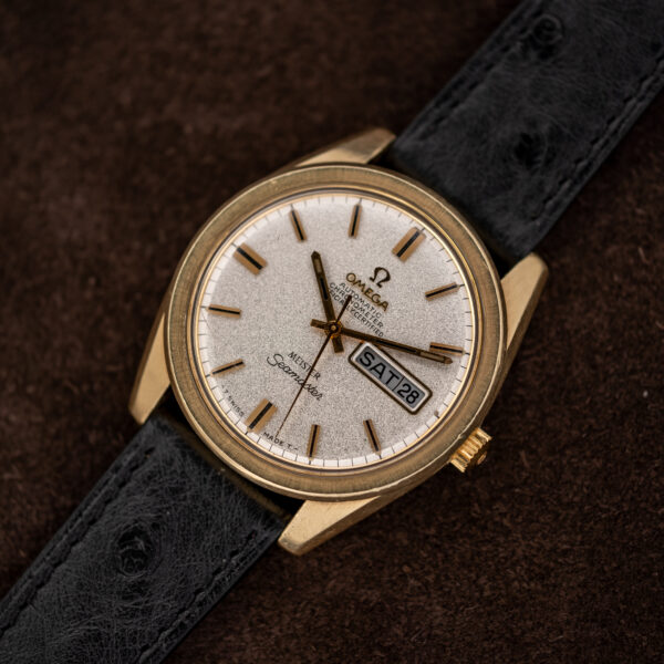 Omega Seamaster 168.023 on black ostrich strap, showing textured dial and rectangular day-date aperture